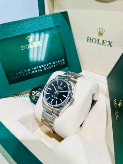 Rolex Oyster Perpetual 34mm stainless steel black index dial and smooth bezel model# 124200