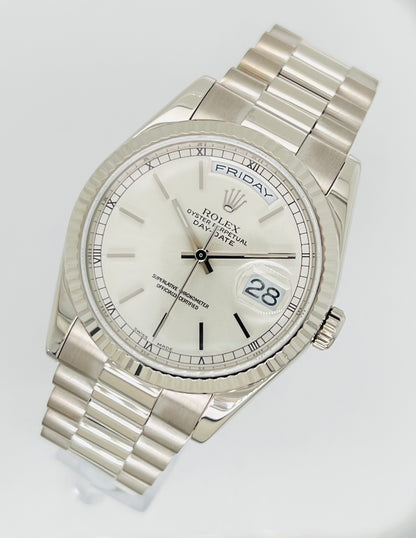 Rolex Day-Date 36mm, White Gold Silver Index Dial with Roman Indices, 18k White Gold Fluted Bezel, White Gold Case, 18k White Gold Presidential Bracelet. Model# 18239